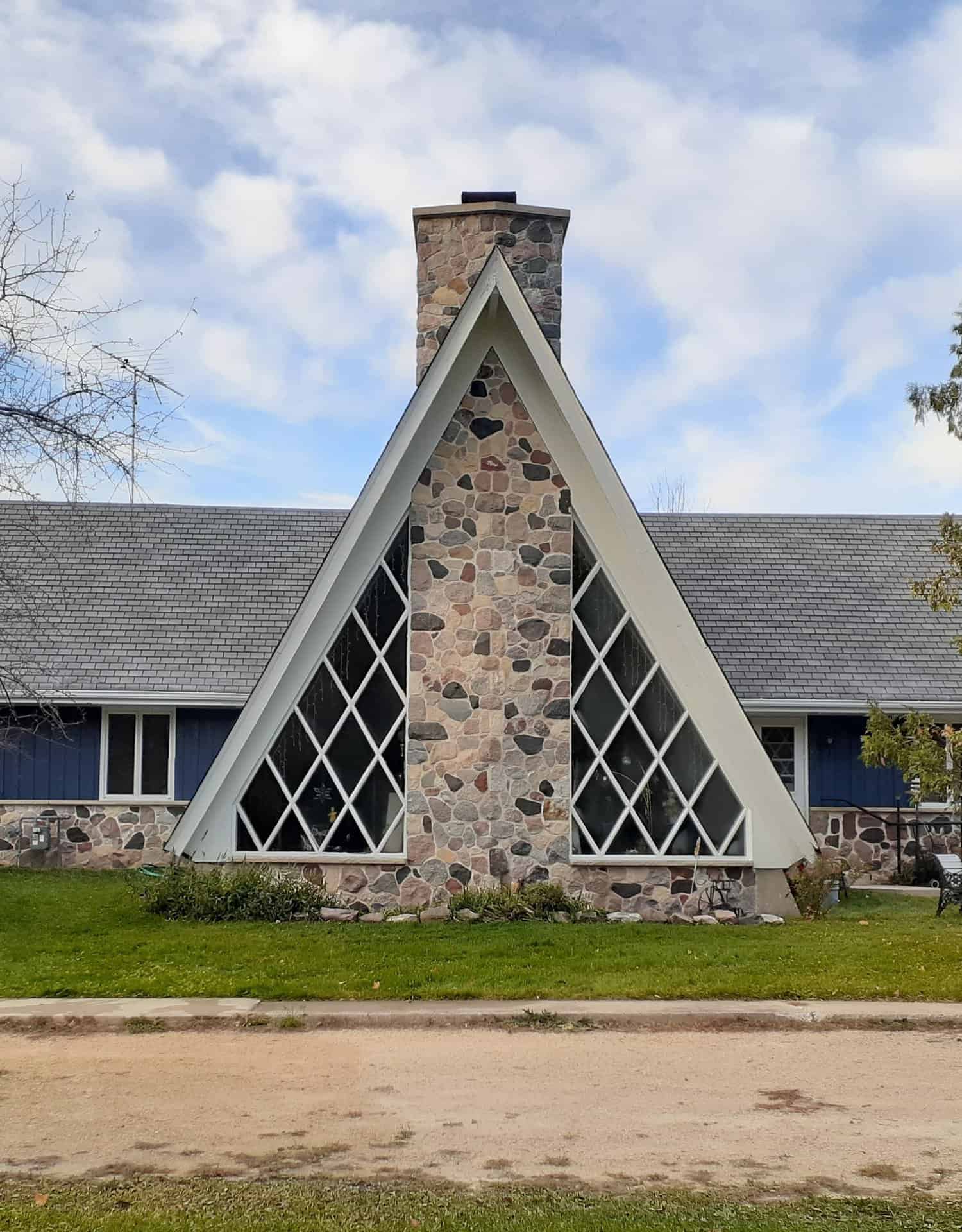 modern building with stone chimney in the middle