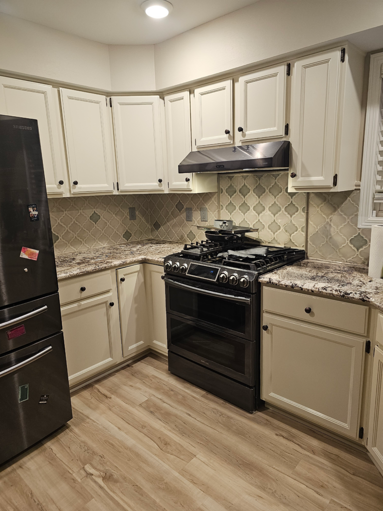 White kitchen cabinet with stainless steel appliances