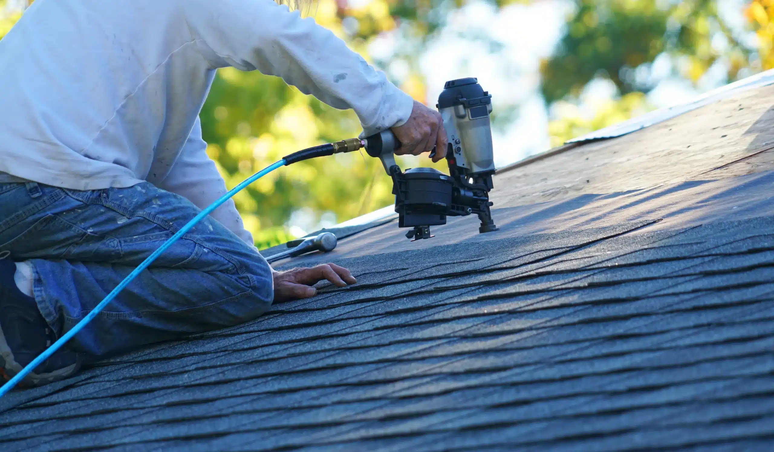Expert Roof Installation for Comprehensive Exterior Home Services A professional installing new asphalt shingles on a residential roof, showcasing quality craftsmanship for exterior home improvement projects.