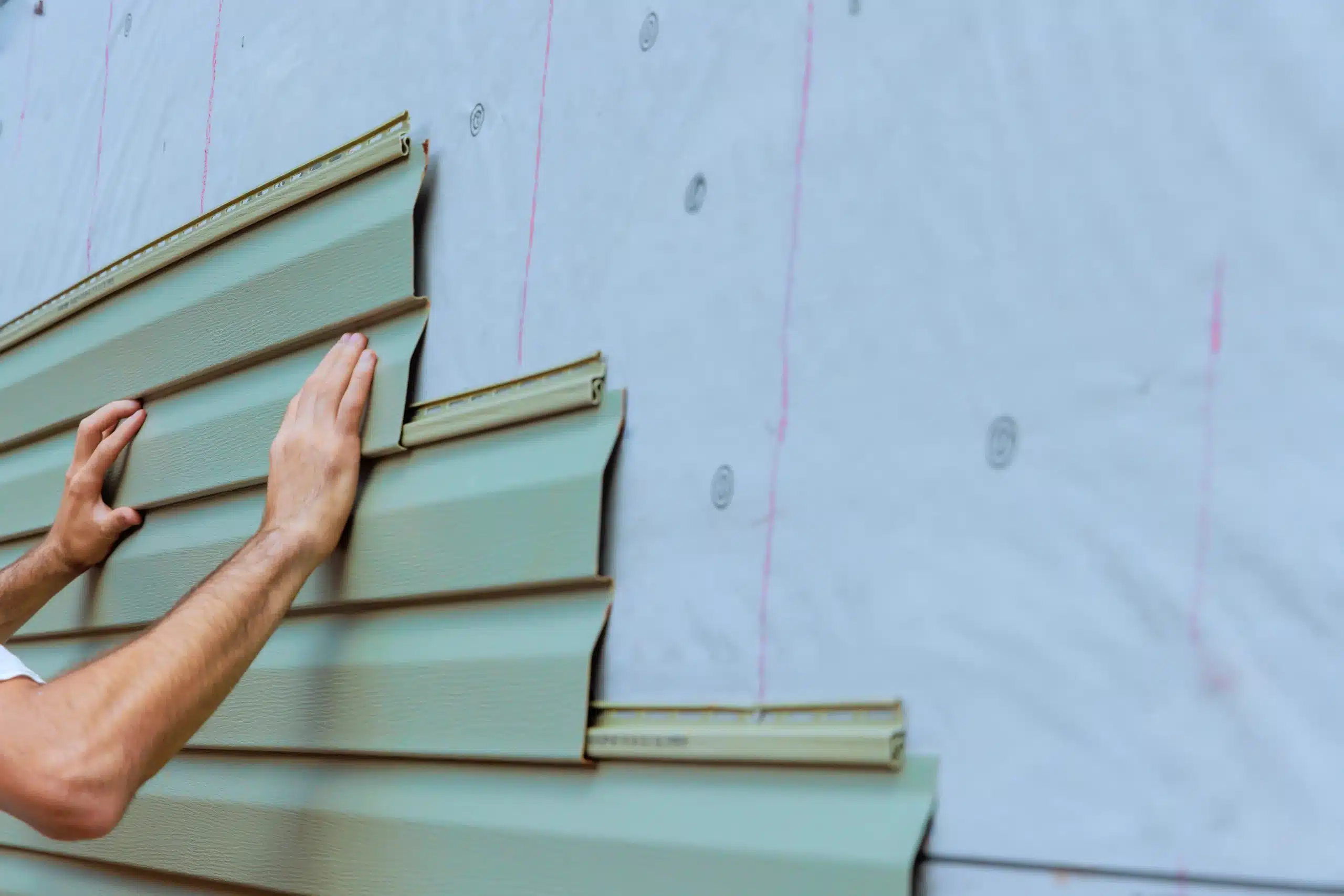 Professional Siding Installation for Exterior Home Improvement A showroom display features various custom wood tone and colored horizontal window treatments or blinds.
